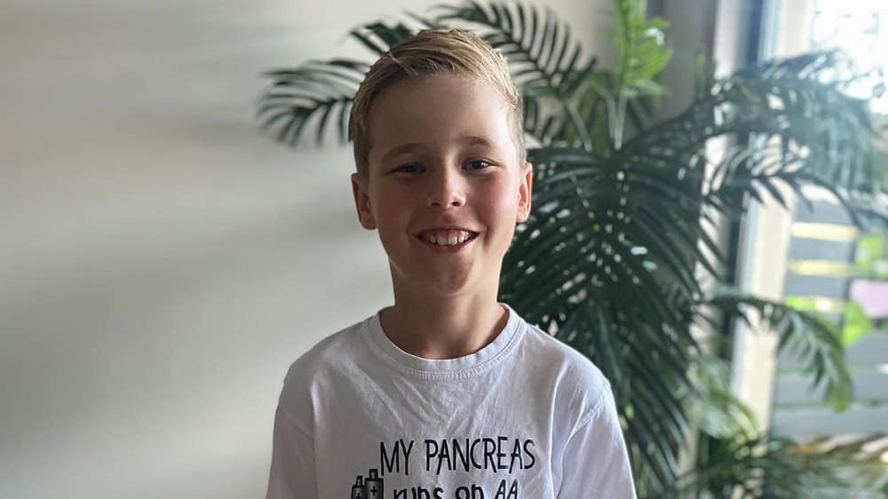 Dexter smiling and standing indoors