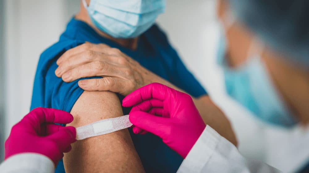 wound care health professional placing plaster on arm