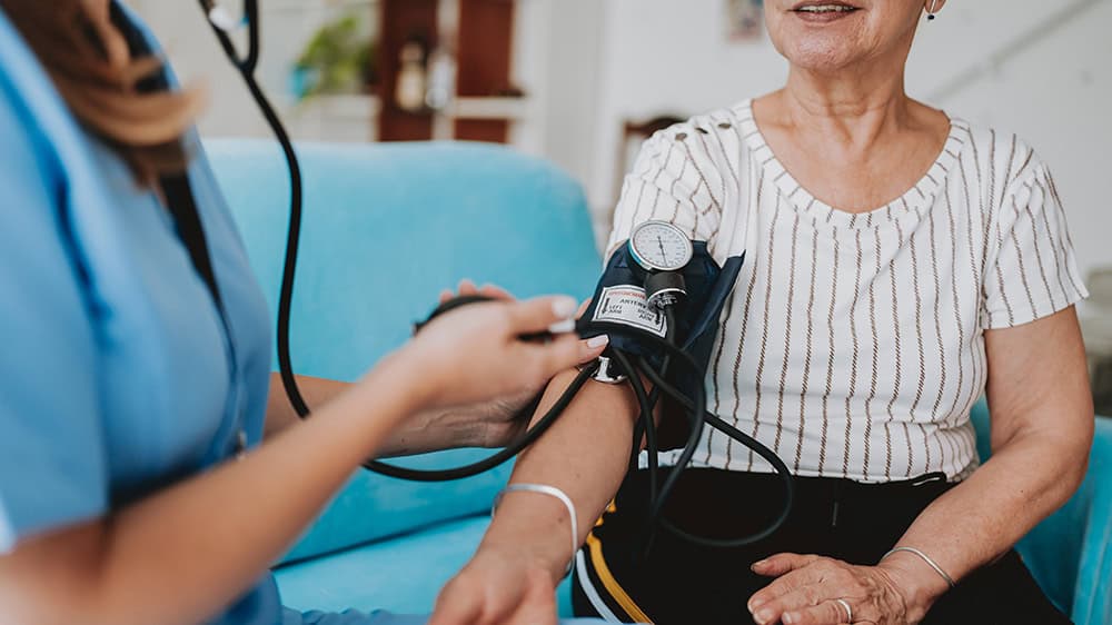 Woman having her blood pressure checked