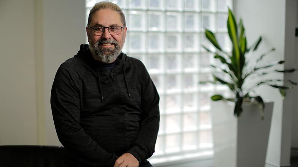 Greg sitting inside room