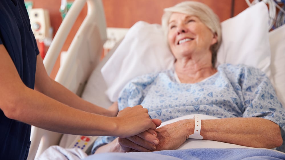 woman smiling in hospital bed
