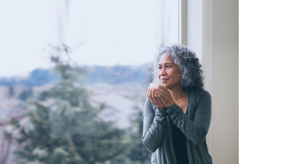 reflective thinking, woman holding mug