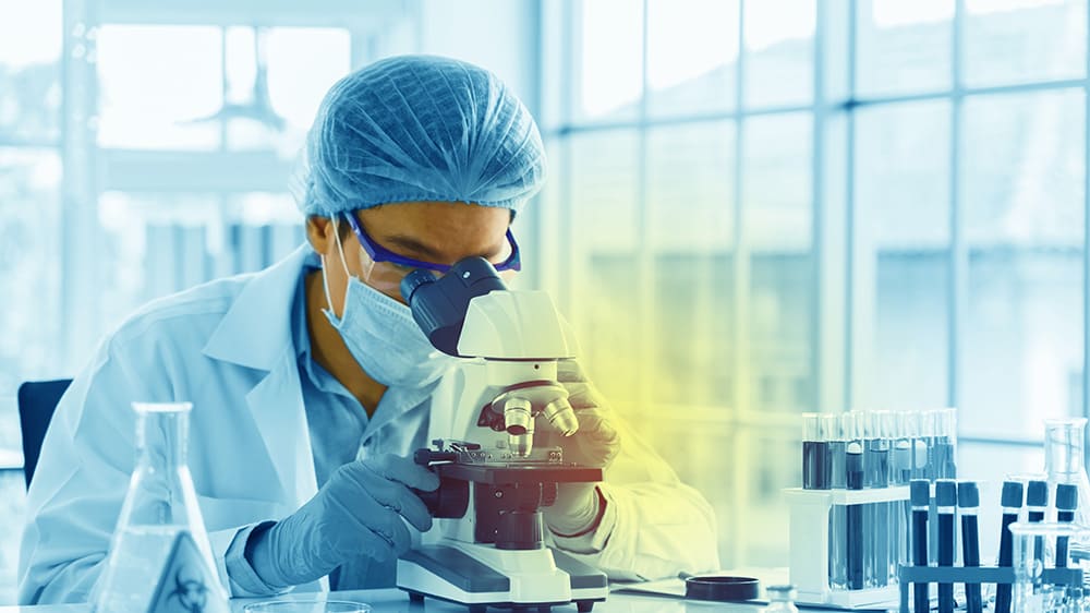 Scientist using a microscope for diabetes research