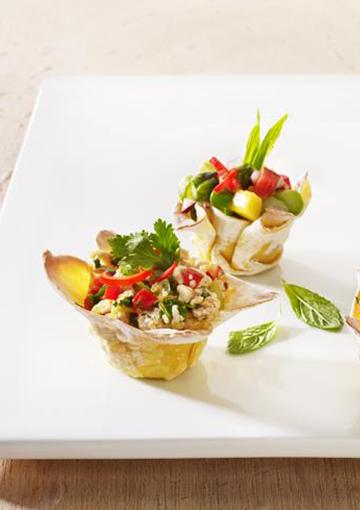 wontons with mango salsa garnished with mint and chillies